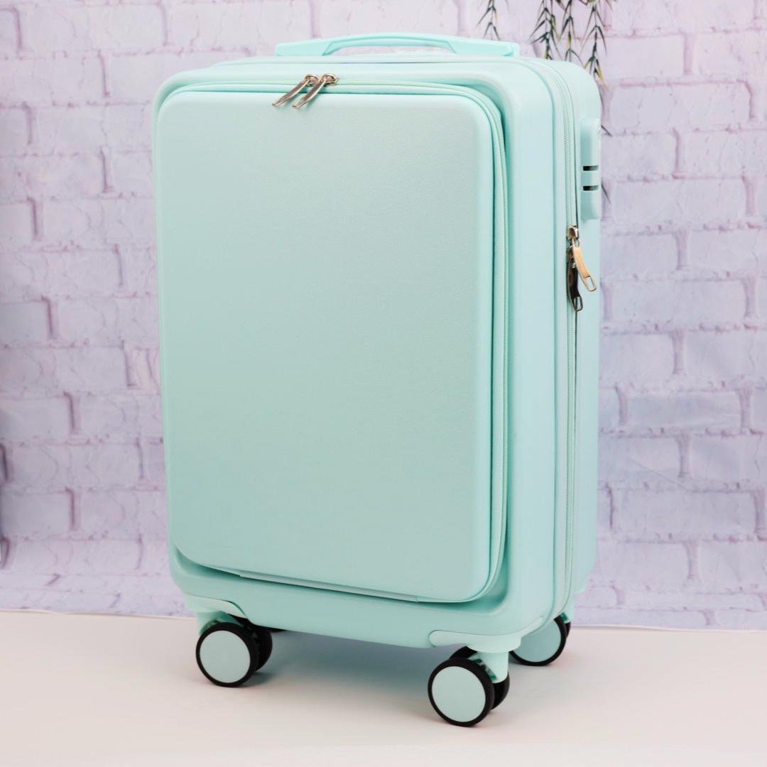 Angled front view of a plain mint green carry-on suitcase showing the zippered front panel and spinner wheels