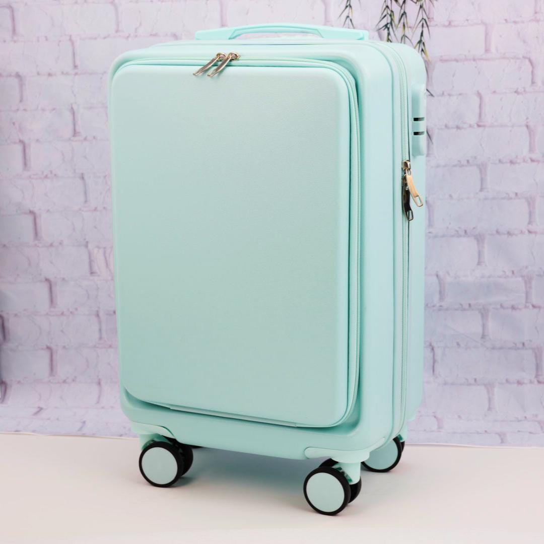 Angled front view of a plain mint green carry-on suitcase showing the zippered front panel and spinner wheels