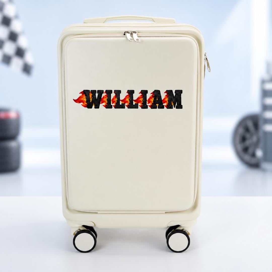 White personalized carry-on suitcase with example name William in black lettering accented by red and orange flames