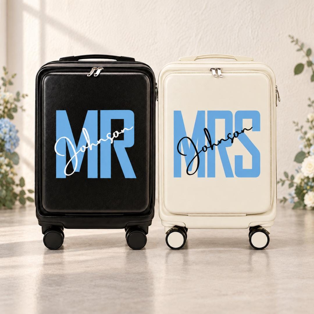 Black Mr and white Mrs carry-on suitcases with blue lettering and example surname Johnson in script