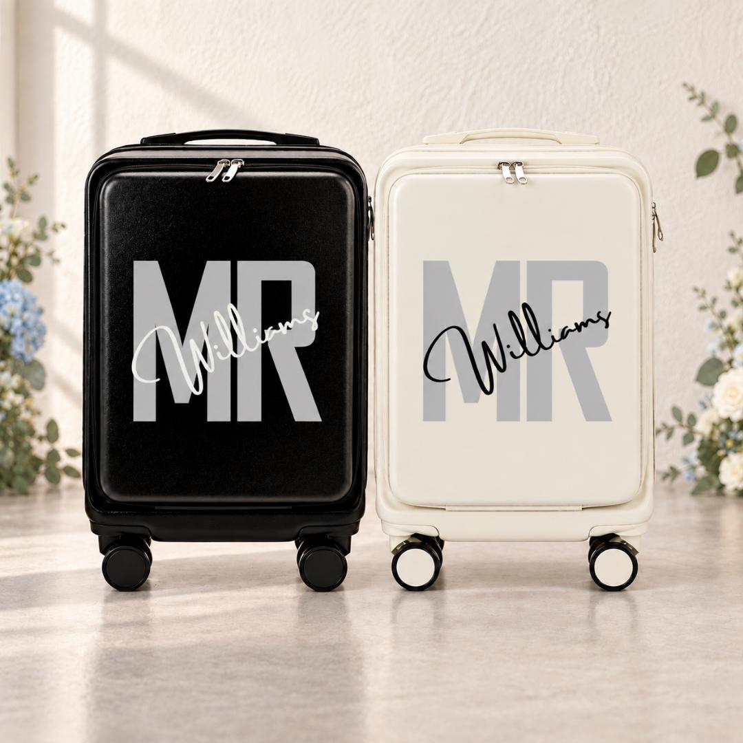 Black and white carry-on suitcases with gray Mr lettering and example surname Williams in contrasting script