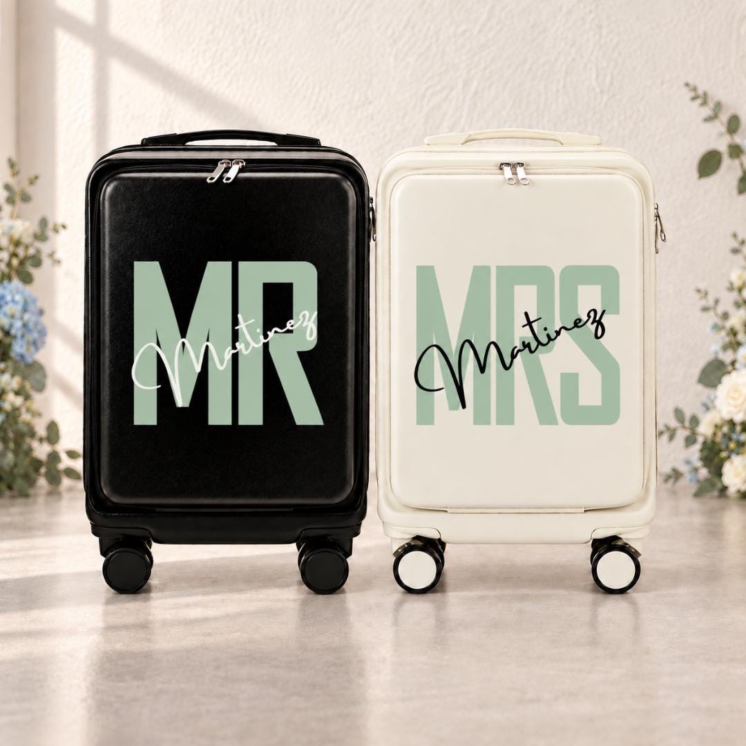 Black Mr and white Mrs carry-on suitcases with mint green lettering and an example personalized surname in script